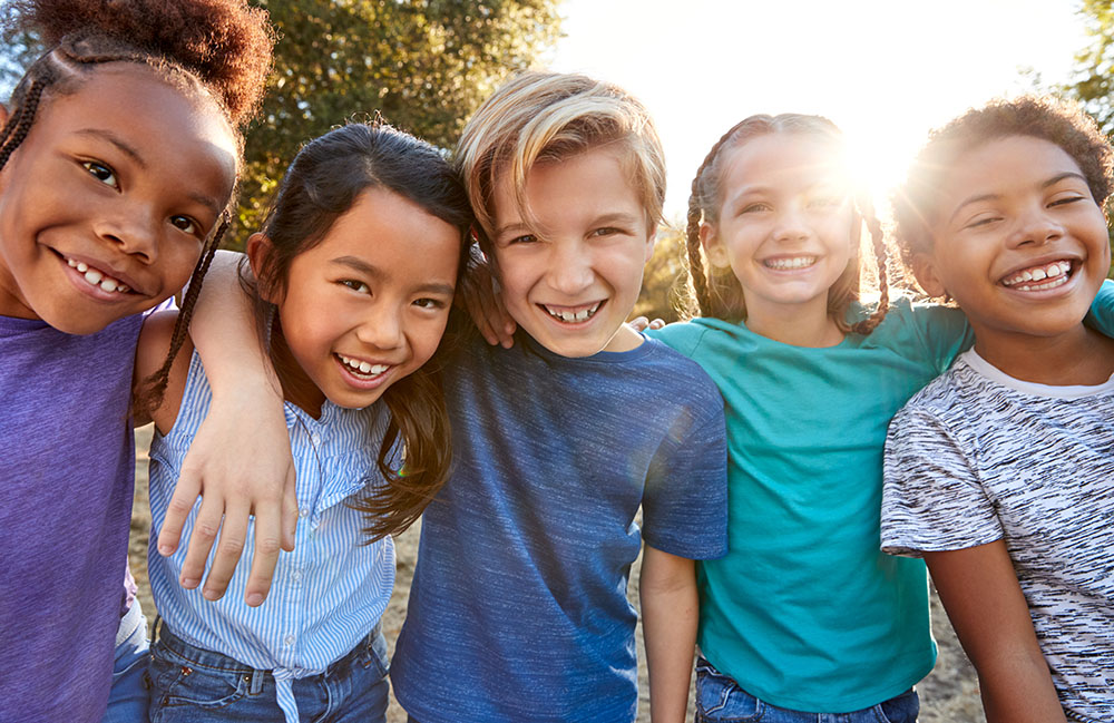 Energetic group of schoolchildren in NYC enjoying a sunny day, embodying ABC School Photography's spirit.